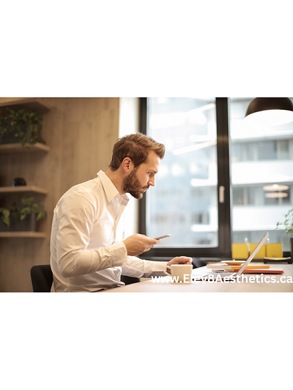 Young man focused on his PC, optimizing his health and productivity with Elev8 Aesthetic Medicine’s wellness care.